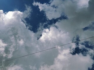 Electrical wire under white clouds