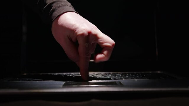 Fingers of person's hand dancing cancan on laptop keyboard close-up. Expressing joy, success, good mood with hands.