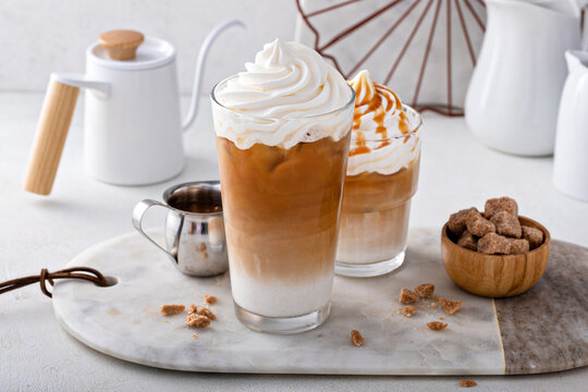 Iced caramel latte topped with whipped cream and caramel sauce