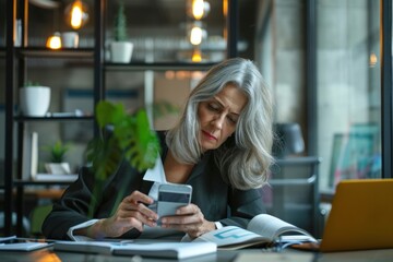 Adult businesswoman inside office at workplace received online notification message with bad news on phone, female boss with gray hair using phone frustrated and displeased reading online,GenerativeAI