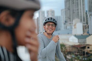 A young cycling couple share a tender moment while cycling in the city.