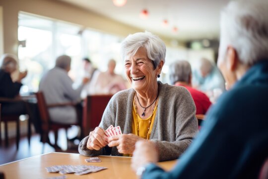 Happy elderly retired woman playing cards with friends in community center - Powered by Adobe