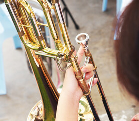 The girl placed the trumpet on her lap, a sparkling gold trumpet. Little hair is the foreground...