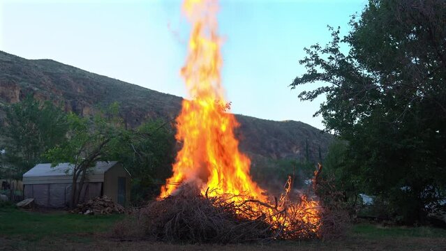 Large pile of wood burning, fire prevention techniques