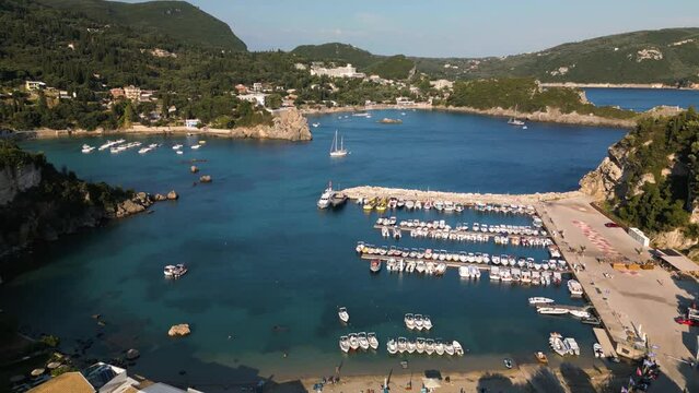Panoramic aerial establishes busy crowded harbor of Corfu Greece with beaches