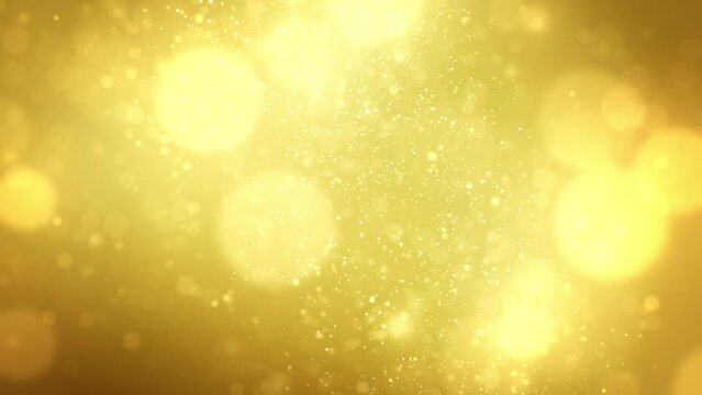 Abstract holiday background with blurred glowing bokeh lights in shades of gold and yellow