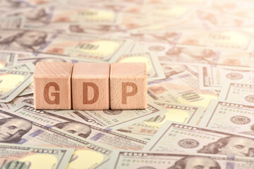 There are blocks with GDP letters printed on the US dollar props