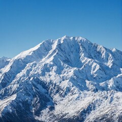 A snow-capped mountain range against a clear blue sky.