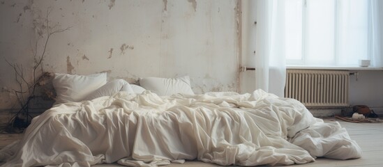 Fototapeta na wymiar Rumpled white bedding in a bedroom.