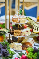 A multi-storey dish with desserts. Cakes and pastries for the festive table.