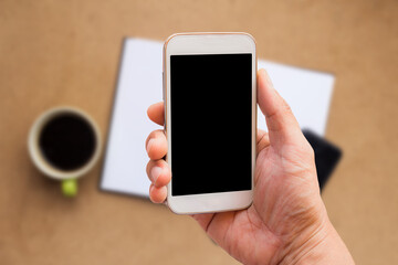 Hand is holding a smartphone with blank mockup screen
