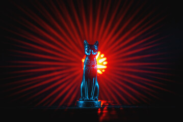 Ancient Egypt goddess Bast (Bastet) silluethe in the lights close up.