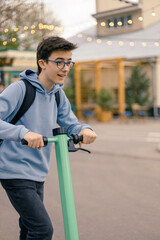 Teenager rides an electric scooter in the city