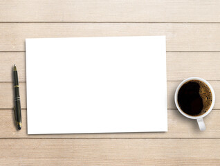 Blank paper,pen and cup of coffee on brown wood table background.