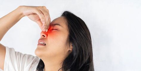 Asian woman hurts her nose because she has a cold. Woman having a headache.