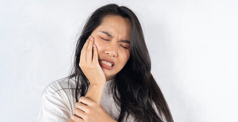 Face expression suffering from sensitive teeth and cold, asian young woman, girl feeling hurt, pain touching cheek, mouth with hand.