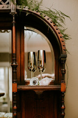 gold champagne wedding flutes in wooden display stand