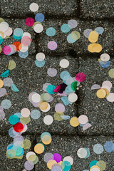 looking down at colourful wedding confetti on the sidewalk