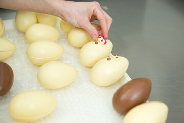 a hand decorating easter eggs