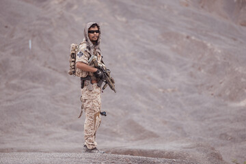 Soldiers in camouflage military uniforms carrying weapons, Reconnaissance missions in rugged mountains, Assault infantry battle training.