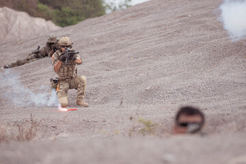 Soldiers in camouflage military uniforms carrying weapons, Reconnaissance missions in rugged...