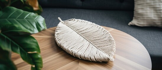 Handcrafted cotton rope macrame leaf on wooden table for cozy room decor