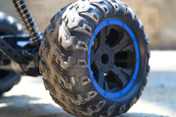 Toys Photography. Closeup Toys. Macrophotography of RC (Remote Control) Car tires. Closeup shot of tire groove texture with blue rims. Shot with a macro lens