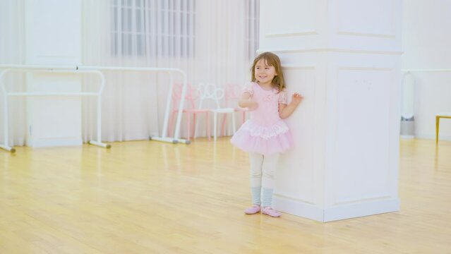 Little Child Ballerina Playing Posing Game With Teacher After Ballet Studio Class, Smiling - Slow motion