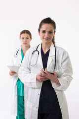 Two female healthcare workers wearing uniform and stethoscope.