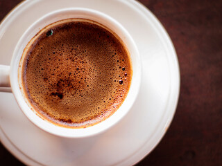 a cup of hot coffee with foam