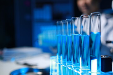 A chemist is testing a newly discovered chemical using a variety of scientific equipment in his lab, The working atmosphere in the laboratory while scientists are doing research.