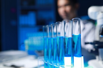 A chemist is testing a newly discovered chemical using a variety of scientific equipment in his lab, The working atmosphere in the laboratory while scientists are doing research.