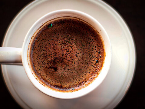 a cup of black coffee on the table