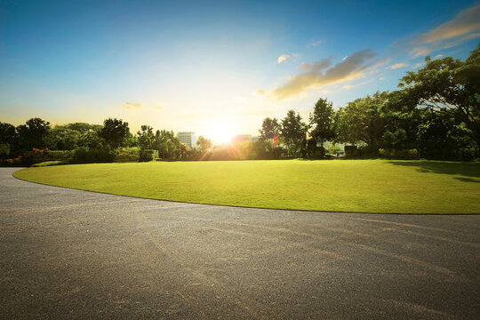 Empty street at the nice and beautyful garden during the sunrise.