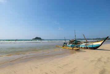 Weligama, February 14, 2024. Boats on Weligama City Beginner's Surf beach on the southern coast of Sri Lanka