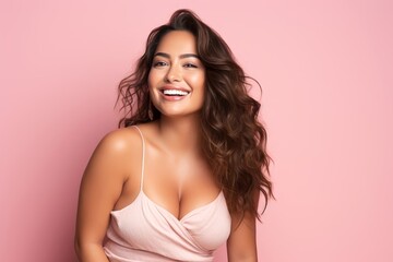 Obraz na płótnie Canvas A radiant plus-size female model, age 25, Hispanic, smiling brightly against a gentle pink backdrop, showcasing beauty and positivity.