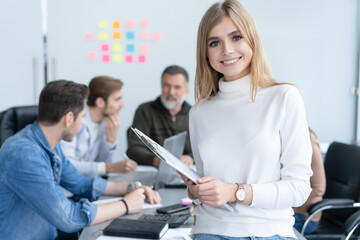 Fototapeta premium Portrait modern business woman in the office with copy space. Female executive wearing casual standing in modern meeting room