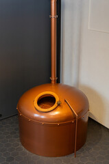 Copper brewing tank with wort in old brewhouse.