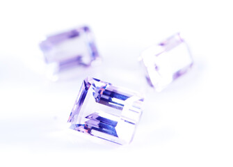 Amethyst, stone or gem in studio by background for natural resource, jewelry and baguette for luxury. Rocks, gemstone or purple crystal in closeup for shine, glow and brilliant with cut for wealth