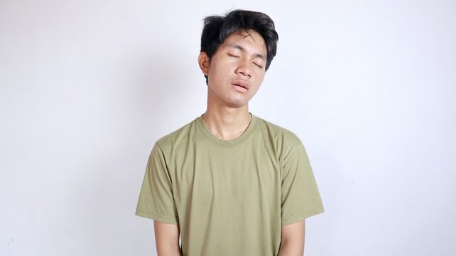 Asian man gesturing sleepy and tired