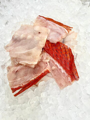 fresh raw cold seafood Seven star whole fish ikan head, fillet, meat, cut, tail on white ice...