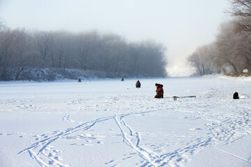 Ice fishing with fishermen. natural background, cold temperature.