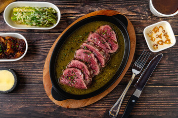 Sliced grilled tenderloin flavored with sauces after being seared on the grill