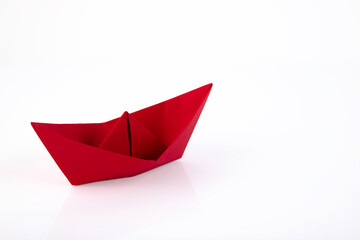 Red paper ship made of paper isolated on white background. Copy space.