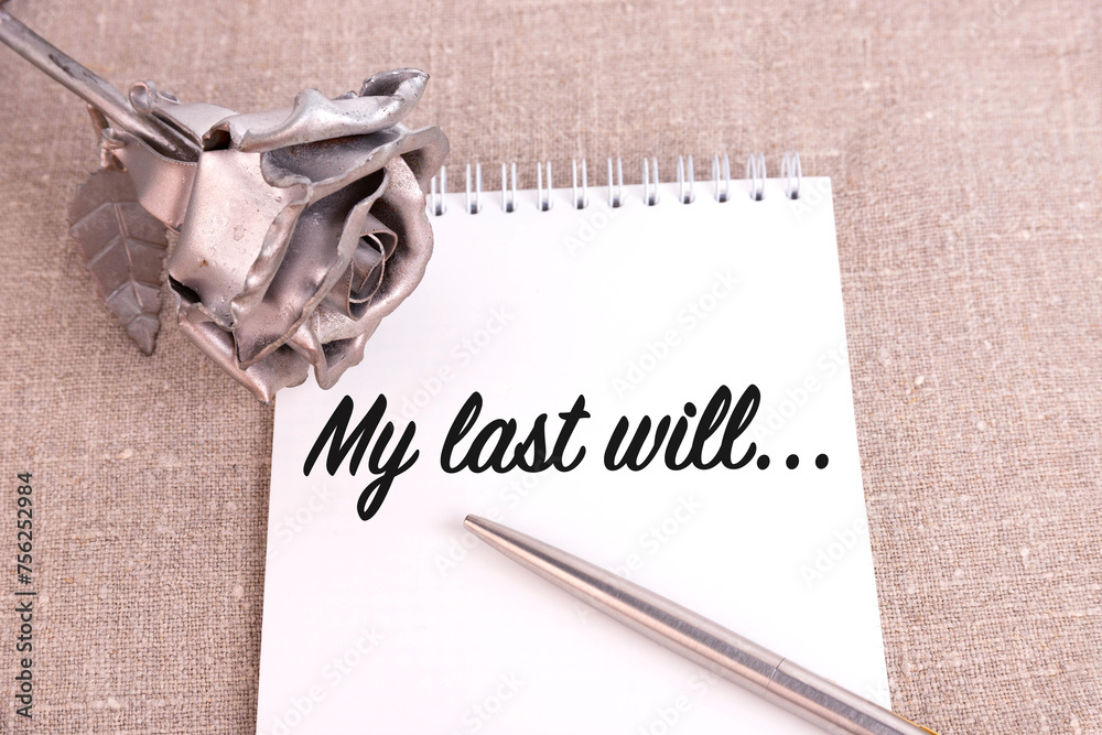 Fototapete my last will, the text is written in a notebook lying on a linen linen and an iron rose flower.