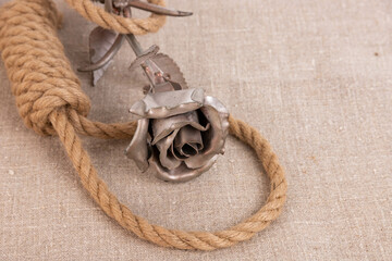 Life is short, suicide rope noose on linen canvas and iron rose flower.