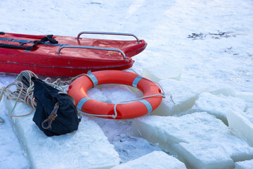 Lifebuoy on the ice of a frozen river