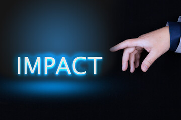 IMPACT text is a word written in neon letters on a black background pointed to by a hand with a...