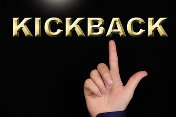 KICKBACK text, a word written on a black background pointed to by a hand with the index finger of a person.