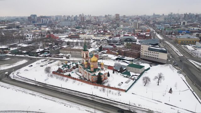 City Barnaul view of the city and church, Altai, Russia. Flying a drone over a winter cityscape.